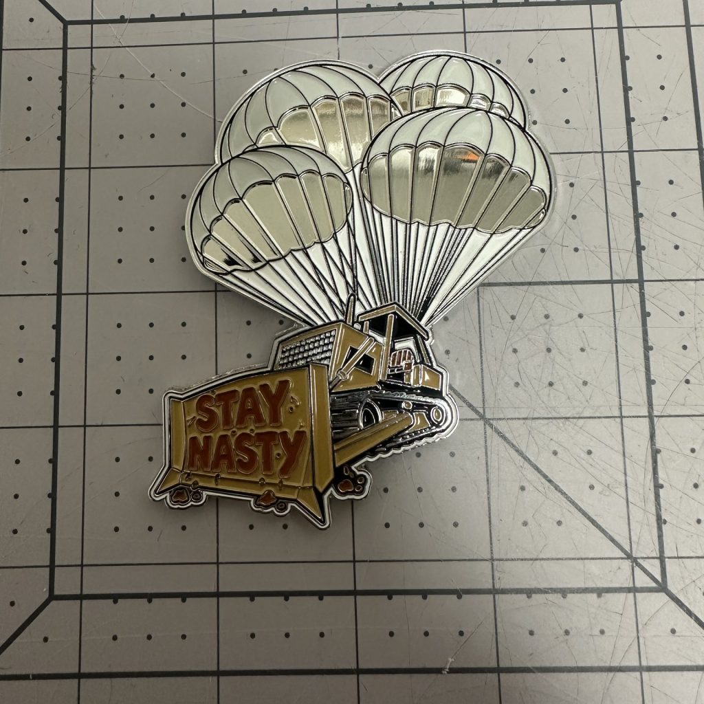 Custom die-cut challenge coin with parachute artwork