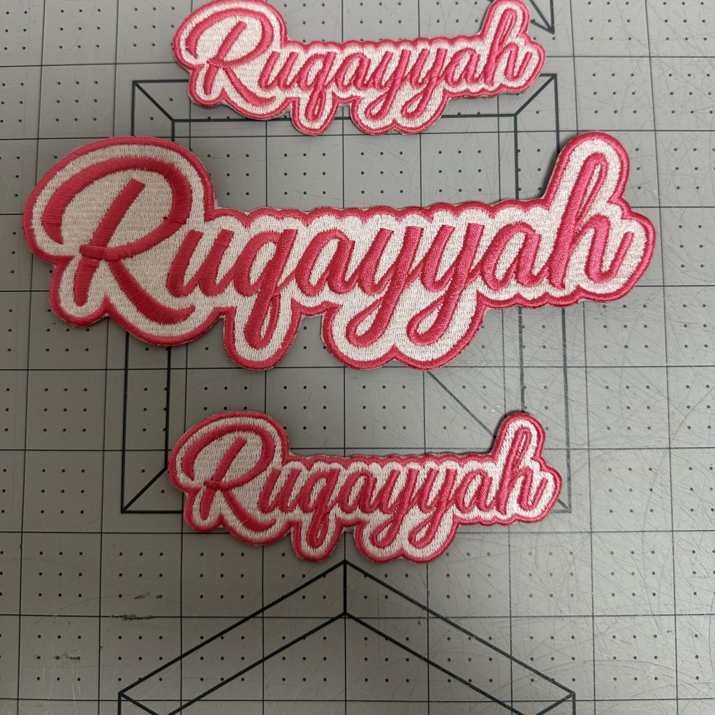 Custom embroidered name patches in pink script lettering