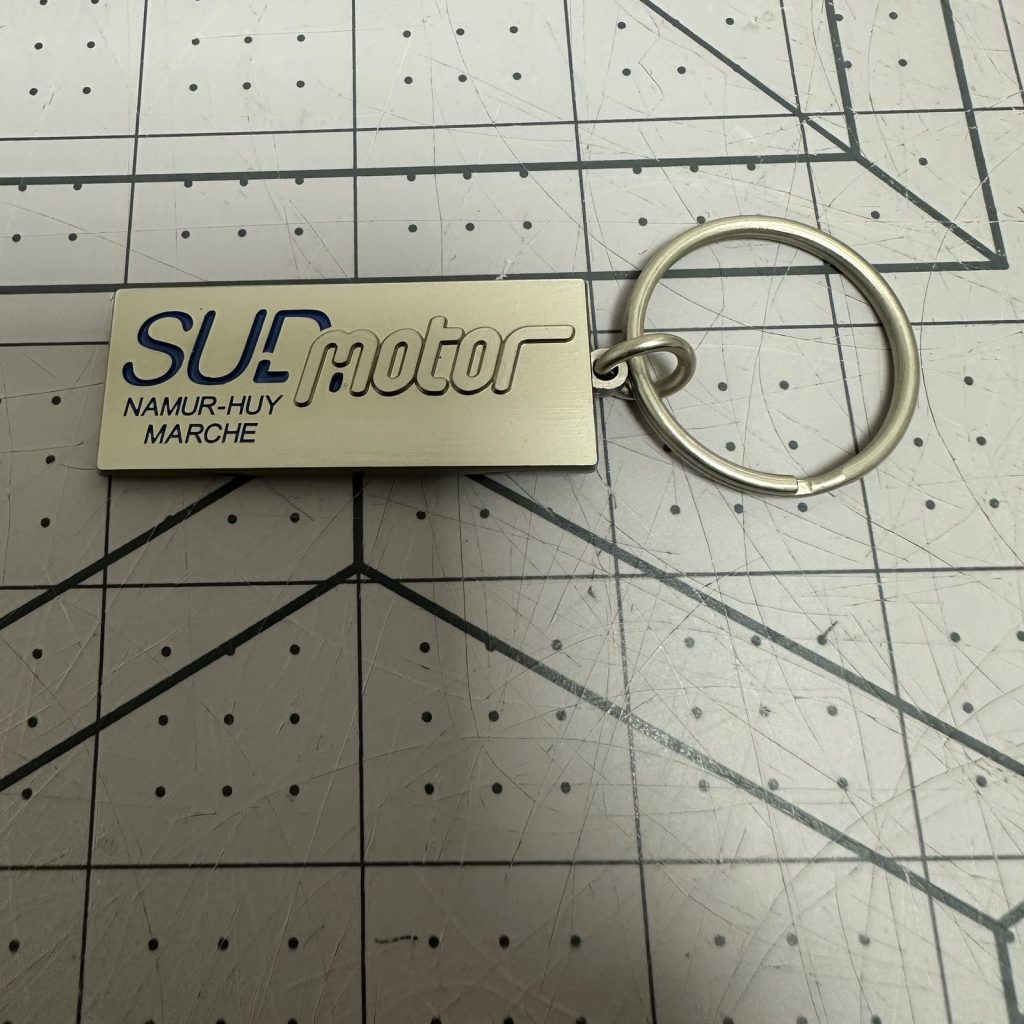 Custom brushed metal keychain tag with engraved logo