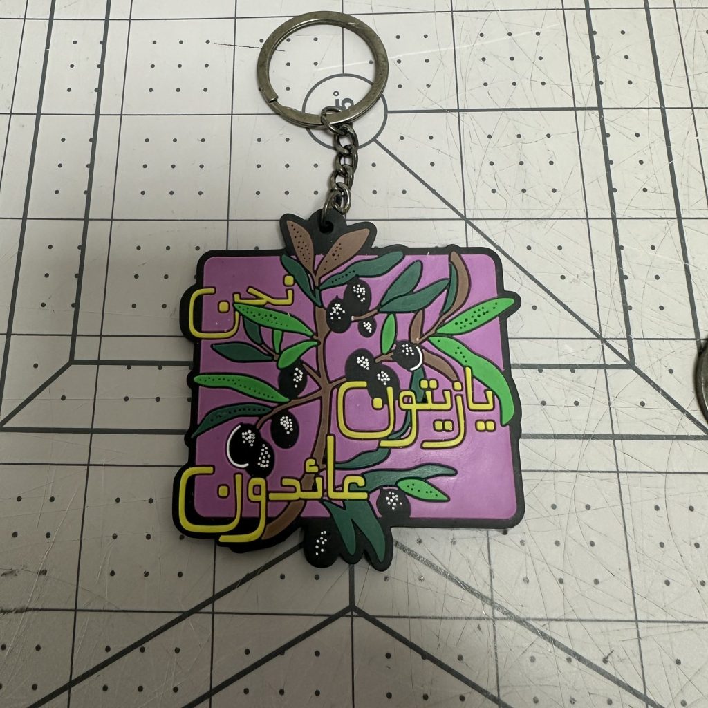 Custom PVC keychain with Arabic lettering and floral artwork