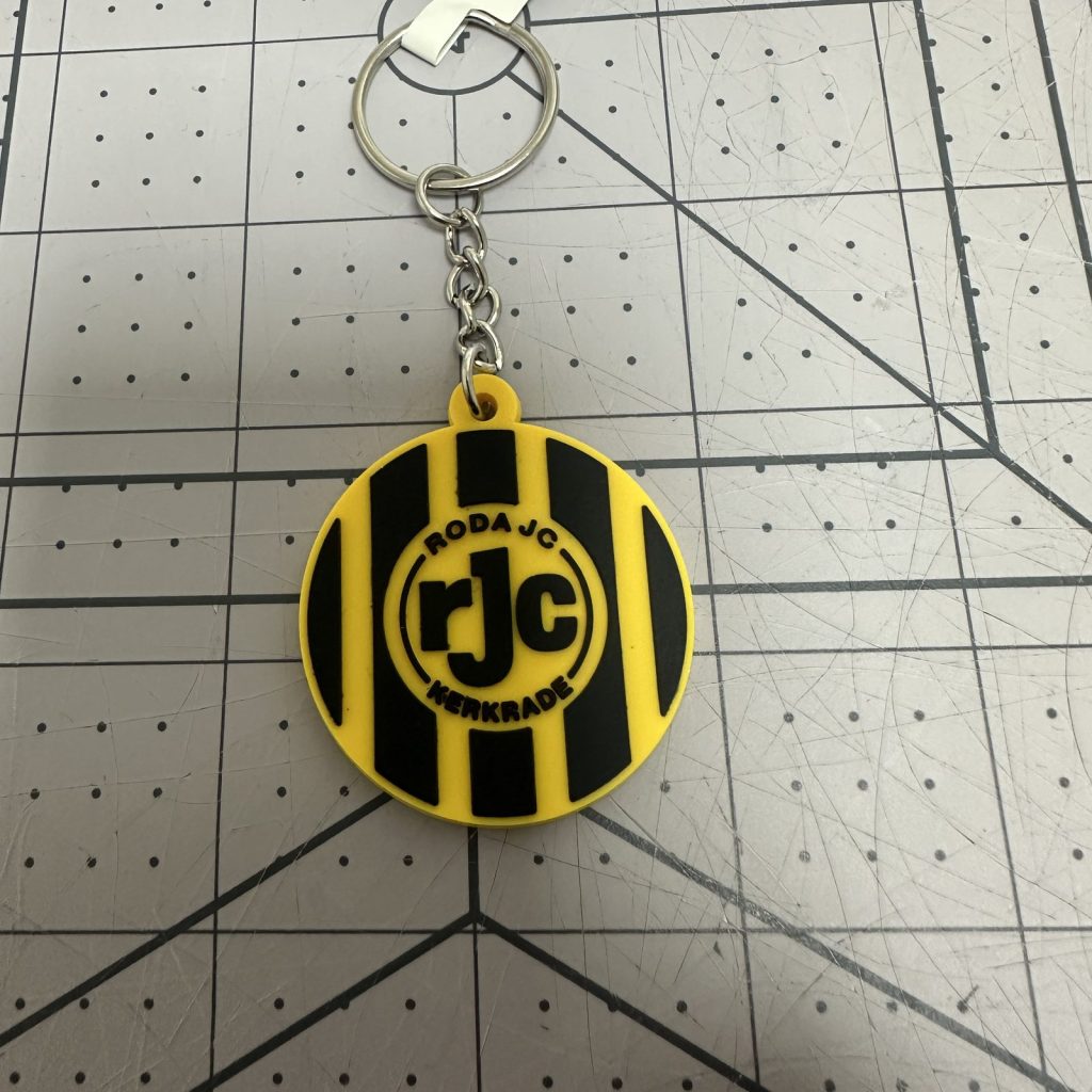 Custom round PVC keychain in yellow and black