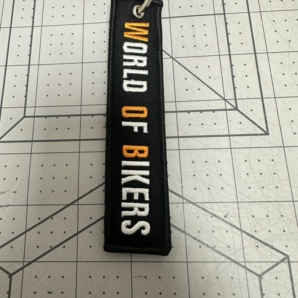 Custom embroidered keychain tag with gold lettering