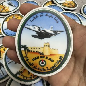 Custom oval PVC patch with a detailed aircraft scene and Arabic lettering
