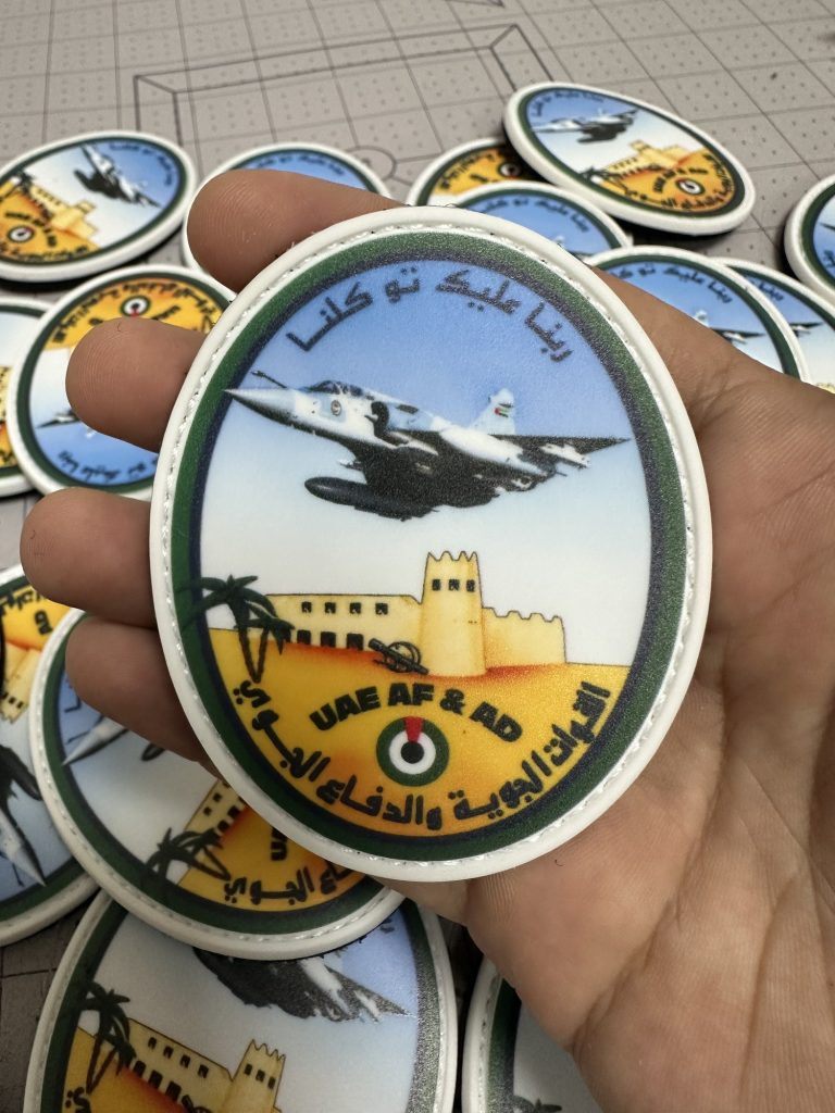 Custom oval PVC patch with a detailed aircraft scene and Arabic lettering